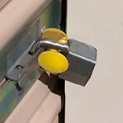 The Padlock Guard securing a roll-up storage shed door